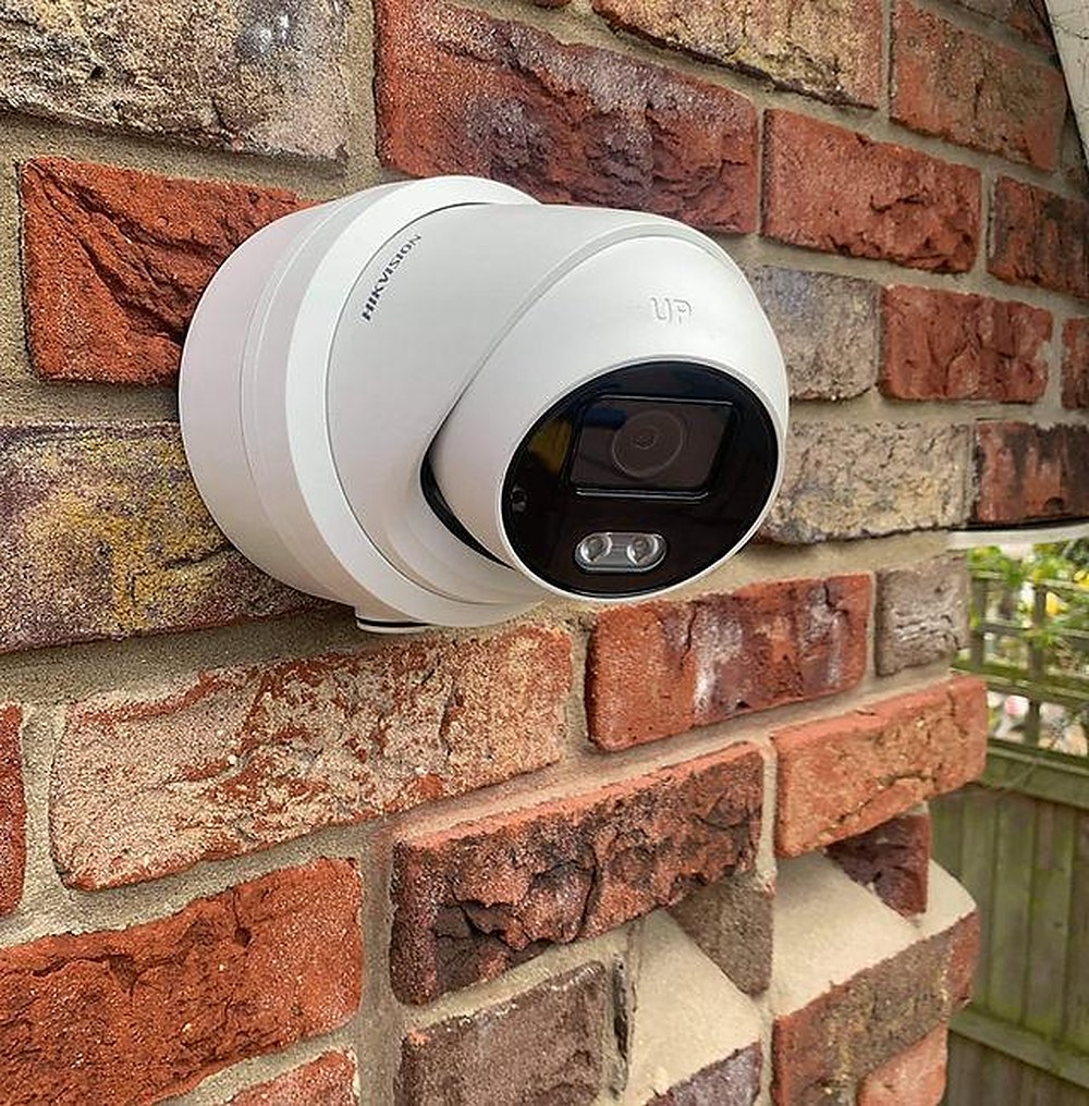 Hikvision CCTV camera fitted to a brick wall in Camden